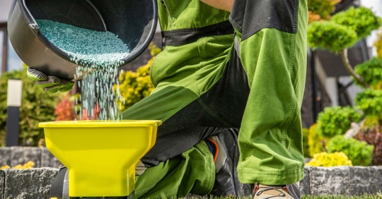 lawn care professional preparing granular stimulant
