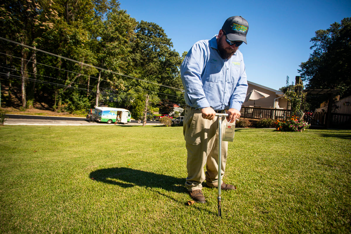 lawn care technician performs soil test