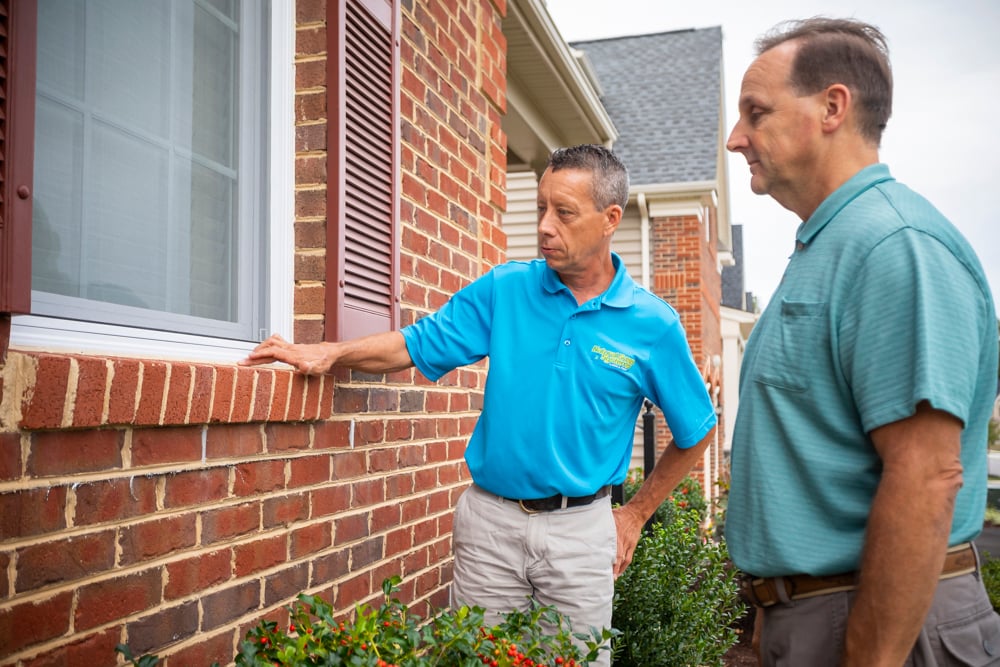 pest control expert consults with client