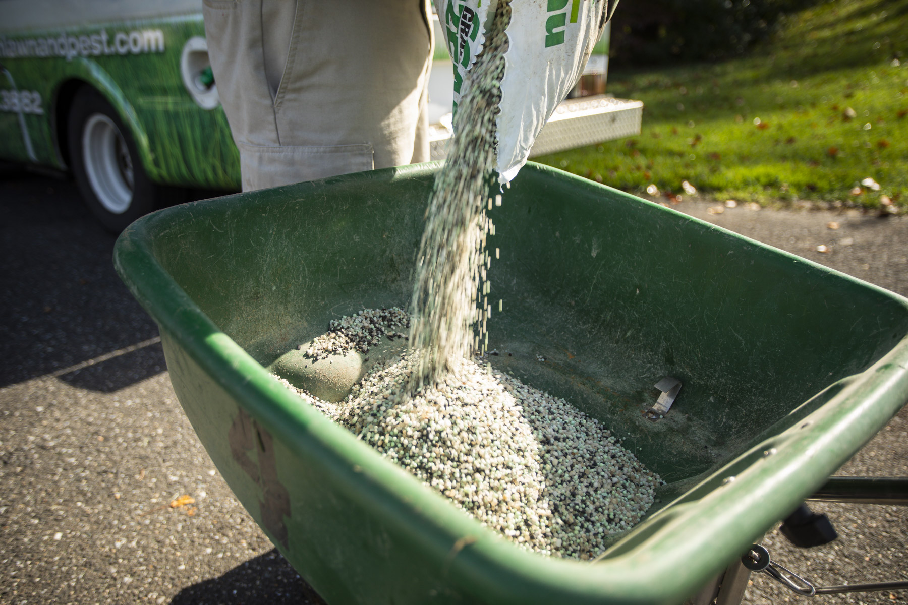 fertilizer being poured into spreader