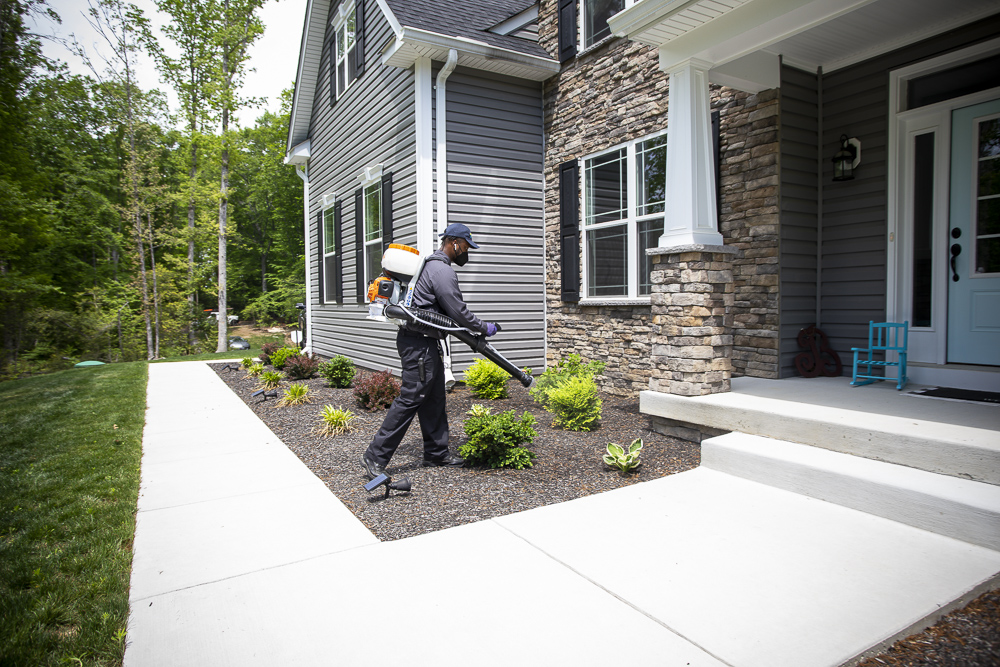 Natural Green pest control technician in Maryland lawn